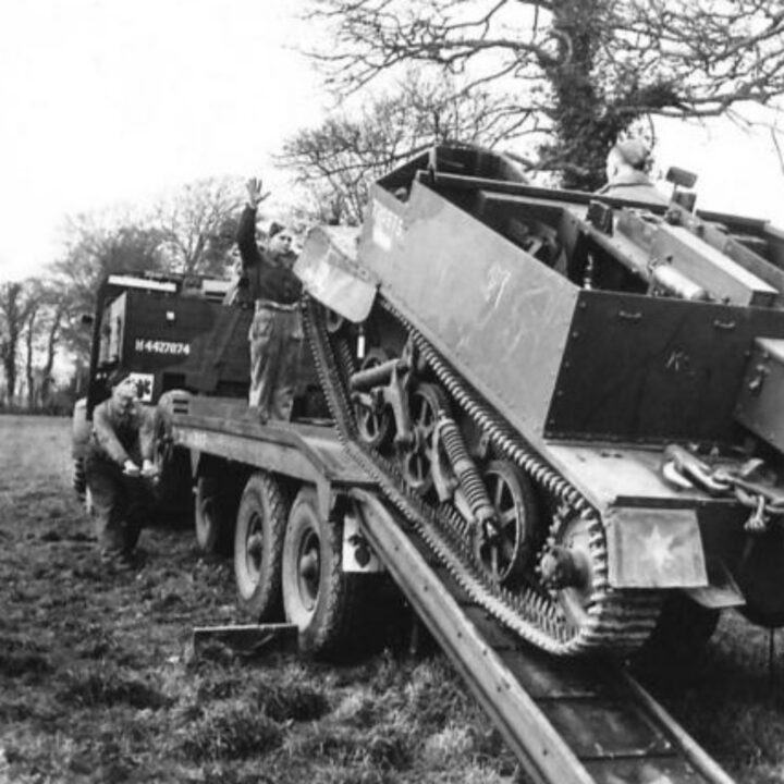 Craftsman Redmore of Cwmcarn, Monmouthshire, Wales, Driver F.J. Woods of Mill Hill, London, England, and Craftsman W.L. Thomas of Southend, England winching a Universal Carrier on to a trailer at 3 Non Divisional Engineers, Royal Electrical and Mechanical Engineers base workshop at Gilford, Co. Down.