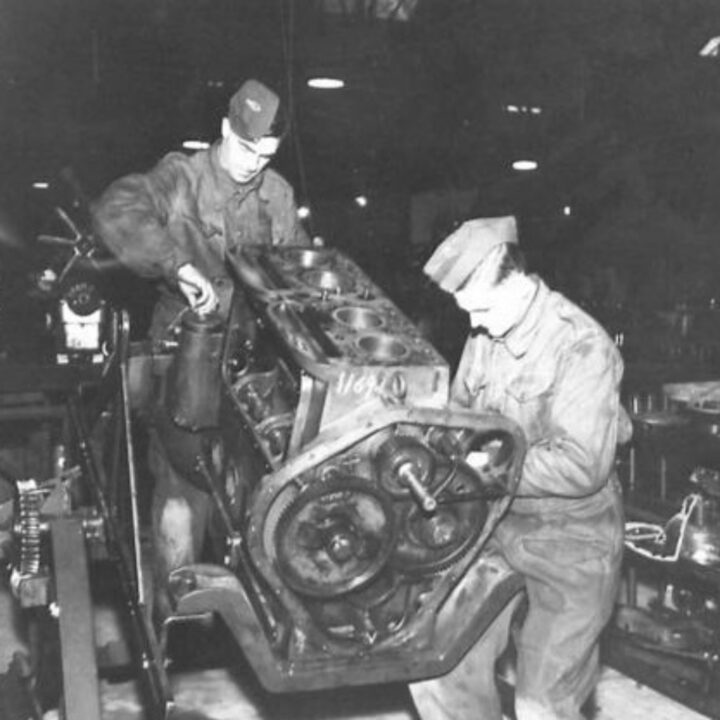 Craftsman A.E. Bell of Sulby, Isle of Man and Craftsman D. Gough of Wolverhampton, England at work overhauling a diesel engine at a Royal Electrical and Mechanical Engineers base workshop at Kinnegar Barracks, Holywood, Co. Down.