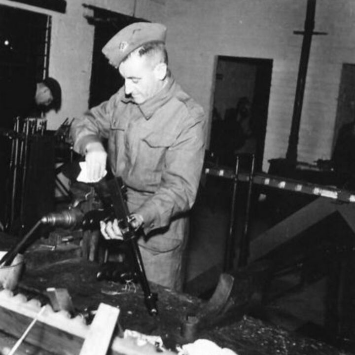 Armourer Staff Sergeant Wiltshire of Dronefield, Sheffield, Yorkshire, England examining a Vickers Machine Gun at a Royal Electrical and Mechanical Engineers base workshop at Kinnegar Barracks, Holywood, Co. Down.