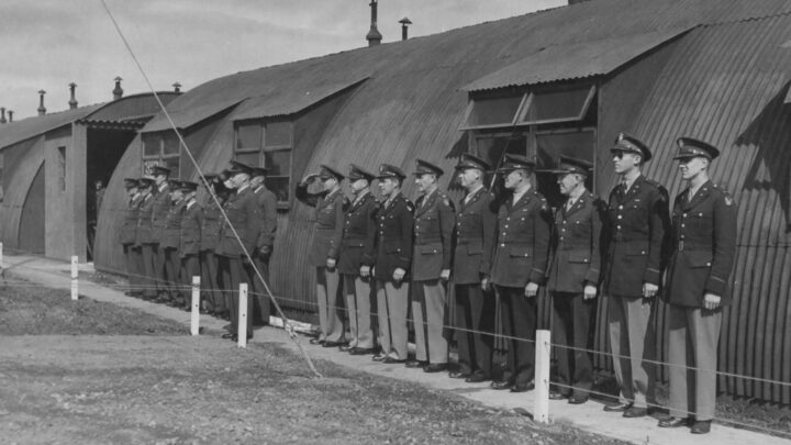 Commissioned personnel of the Royal Air Force and United States Army Air Force stand to attention as R.A.F. Toome becomed U.S.A.A.F. Station 236 at Toome Airfield, Co. Antrim on 26th July 1943.