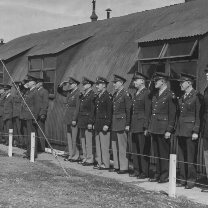 Commissioned personnel of the Royal Air Force and United States Army Air Force stand to attention as R.A.F. Toome becomed U.S.A.A.F. Station 236 at Toome Airfield, Co. Antrim on 26th July 1943.