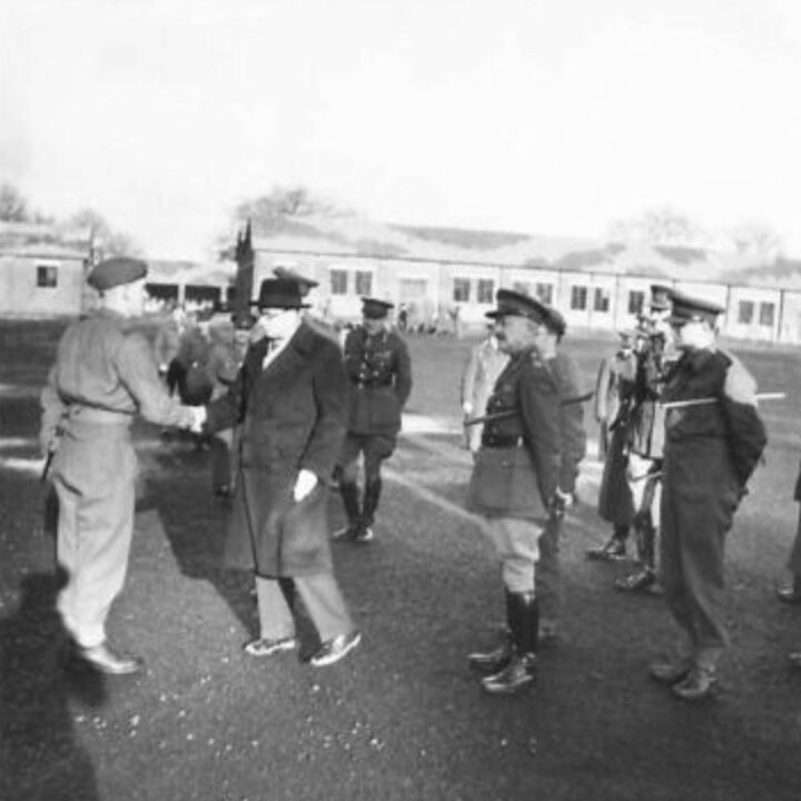 The Right Honourable Sir James Grigg K.C.B., K.C.S.I, P.C. (Secretary of State for War) shakes hands with Sergeant Vogel of Holloway, London, England, congratulating him on the efficiency of his 6-week-old Company at a British Army base in Northern Ireland.