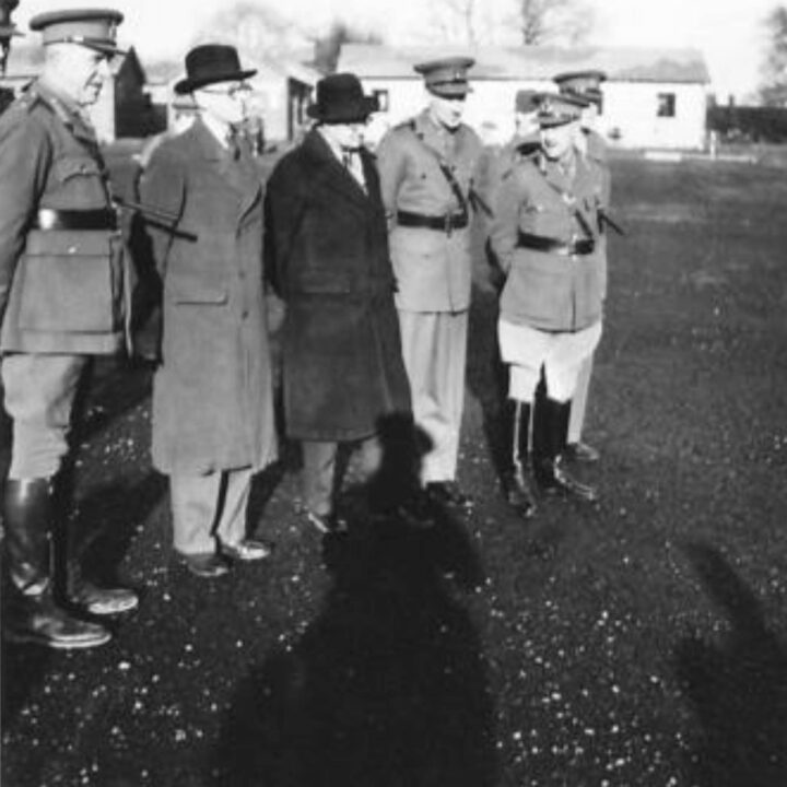 The Honorable R.B. Beaumont M.P. (Principal Parliamentary Secretary to the Secretary of State for War), The Right Honourable Sir James Grigg K.C.B., K.C.S.I, P.C. (Secretary of State for War), Lieutenant General Sir Harold Edmund Franklyn, and Major General Vivian Henry Bruce Majendie at a British Army base in Northern Ireland.