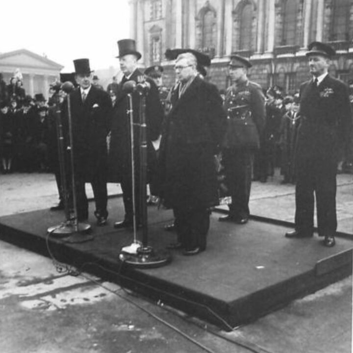 Sir James Grigg K.C.B., K.C.S.I, P.C. (Secretary of State for War) stands next to the Duke of Abercorn (Governor of Northern Ireland) in the grounds of City Hall, Belfast. The occasion is the unveiling of a commemorative stone marking the first anniversary of the official arrival of U.S. troops to Northern Ireland and into the European Theater of Operation.