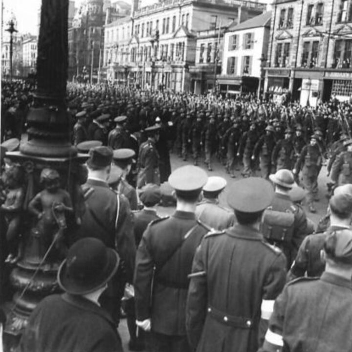 The Duke of Abercorn (Governor of Northern Ireland) takes the salute from a detachment of East Surrey Regiment in front of City Hall, Belfast. The occasion is the unveiling of a commemorative stone marking the first anniversary of the official arrival of U.S. troops to Northern Ireland and into the European Theater of Operation.