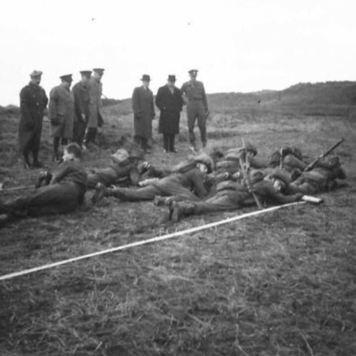 The Right Honourable Sir James Grigg K.C.B., K.C.S.I, P.C. (Secretary of State for War) and Officers observing training at a British Army Battle School in Northern Ireland.