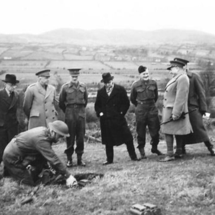 The Right Honourable Sir James Grigg K.C.B., K.C.S.I, P.C. (Secretary of State for War) and Officers observing mine laying training at a British Army Battle School in Northern Ireland.