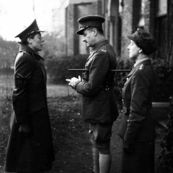 Lieutenant Colonel J. Cheney (Deputy Provost Marshal) accompanied by Junior Commander Abbott inspects members of the Auxiliary Territorial Service Military Police 