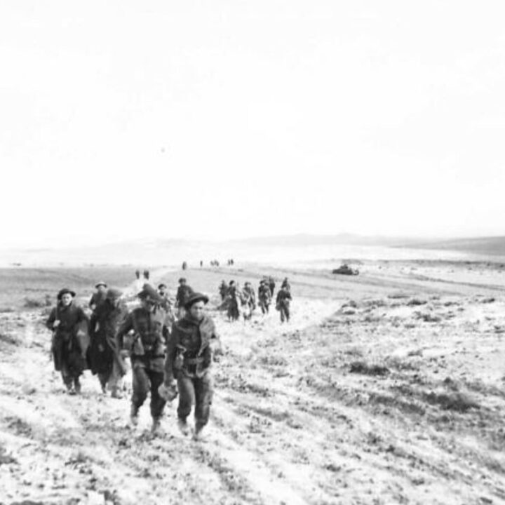 Members of 6th Battalion, Royal Inniskilling Fusiliers withdraw to a rear position having endured terrible conditions during the attack at Two Tree Hill, Bou Arada, Tunisia.