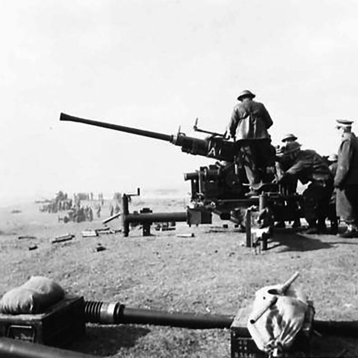 Gunners firing a Bofors Gun. This exercise at 17th Anti-Aircraft Practise Camp, Ballykinlar, Co. Down involved the firing of Bofors Guns at a 'kite' towed behind a military plane.