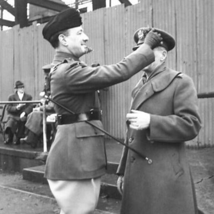 Commanding Officer Lieutenant Colonel Panter of the Royal Ulster Rifles presents the shamrock to an Officer of the United States Army. The event is the presentation of the St. Patrick's Day Shamrock by Brigadier P.H. Hansen V.C. to members of 31st Battalion Royal Ulster Rifles, U.S. Army Officers of Irish descent, and members of the Auxiliary Territorial Service at Dunmore Park, Belfast.