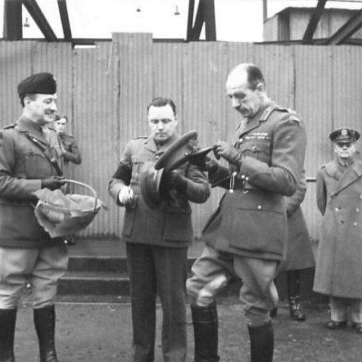 Brigadier P.H. Hansen V.C. places a sprig of shamrock in his cap. The event is the presentation of the St. Patrick's Day Shamrock by Brigadier P.H. Hansen V.C. to members of 31st Battalion Royal Ulster Rifles, U.S. Army Officers of Irish descent, and members of the Auxiliary Territorial Service at Dunmore Park, Belfast.