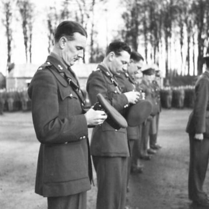 Major R.G. Scott, Second in Command at 25th Initial Training Centre affixes the shamrock to his cap. The event is the presentation of the St. Patrick's Day Shamrock by Mrs. Heard, wife of Lieutenant Colonel R.A. Heard M.C., Commandant of 25th Infantry Training Centre to soldiers in Omagh, Co. Tyrone.