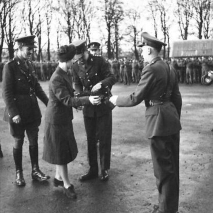 Mrs. Heard distributing the shamrock to soldiers in Omagh, Co. Tyrone. The event is the presentation of the St. Patrick's Day Shamrock by Mrs. Heard, wife of Lieutenant Colonel R.A. Heard M.C., Commandant of 25th Infantry Training Centre to soldiers in Omagh, Co. Tyrone.