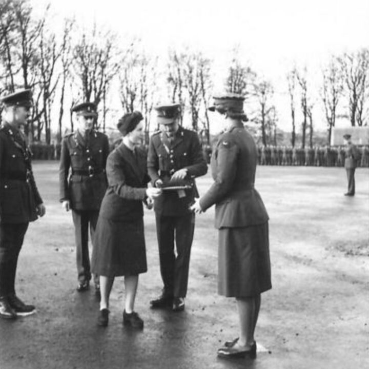 Mrs. Heard presents the shamrock to an Officer of the Auxiliary Territorial Service in Omagh, Co. Tyrone. The event is the presentation of the St. Patrick's Day Shamrock by Mrs. Heard, wife of Lieutenant Colonel R.A. Heard M.C., Commandant of 25th Infantry Training Centre to soldiers in Omagh, Co. Tyrone.
