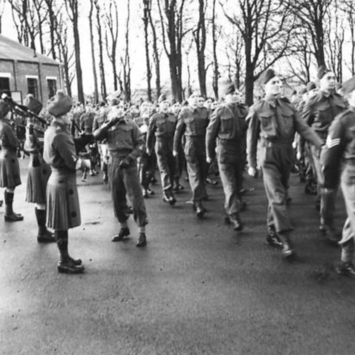 Recruits march past the band at 25th Initial Training Centre following the St. Patrick's Day ceremony. The event is the presentation of the St. Patrick's Day Shamrock by Mrs. Heard, wife of Lieutenant Colonel R.A. Heard M.C., Commandant of 25th Infantry Training Centre to soldiers in Omagh, Co. Tyrone.