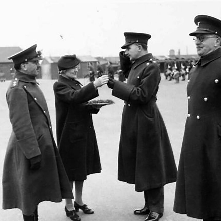 Mrs. Allen, the wife of the Commanding Officer gives a sprig of shamrock to Officers. The event is the presentation of the St. Patrick's Day Shamrock to members of a Battalion of the Royal Irish Fusiliers at Ballykinler, Co. Down.