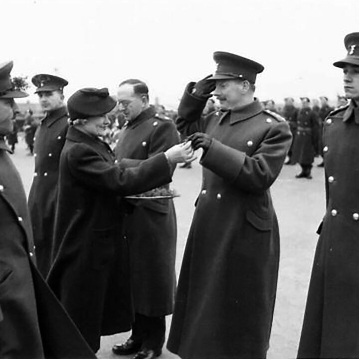 Mrs. Allen, the wife of the Commanding Officer gives a sprig of shamrock to Officers. The event is the presentation of the St. Patrick's Day Shamrock to members of a Battalion of the Royal Irish Fusiliers at Ballykinler, Co. Down.