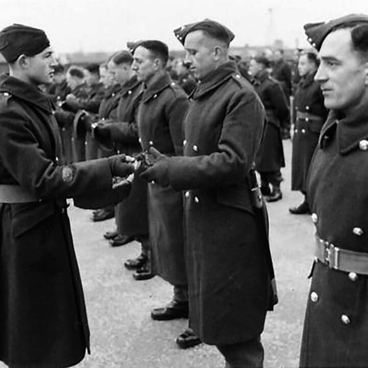 A Sergeant Major hands out sprigs of shamrock to his soldiers. The event is the presentation of the St. Patrick's Day Shamrock to members of a Battalion of the Royal Irish Fusiliers at Ballykinler, Co. Down.