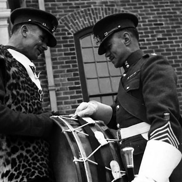 Drum Major Pogue talks to well-known boxer Fusilier Tate about the historic Battle Honours on his drum. The event is the presentation of the St. Patrick's Day Shamrock to members of a Battalion of the Royal Irish Fusiliers at Ballykinler, Co. Down.