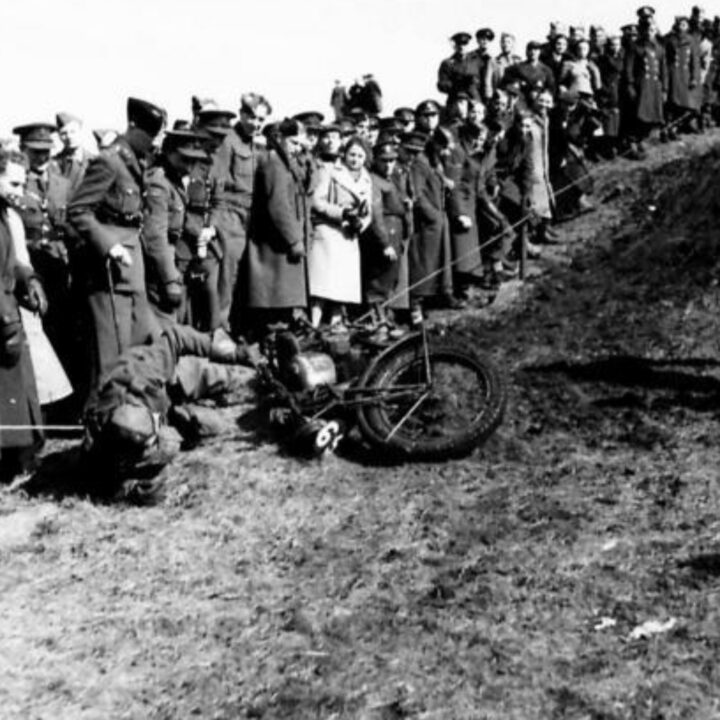 A competitor falls on a muddy section of track. British Army motorcycle trials held at the old lead mines at Whitespots near Conlig, Co. Down.