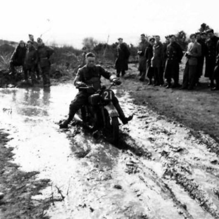 A rider navigates the muddiest section of track. British Army motorcycle trials held at the old lead mines at Whitespots near Conlig, Co. Down.