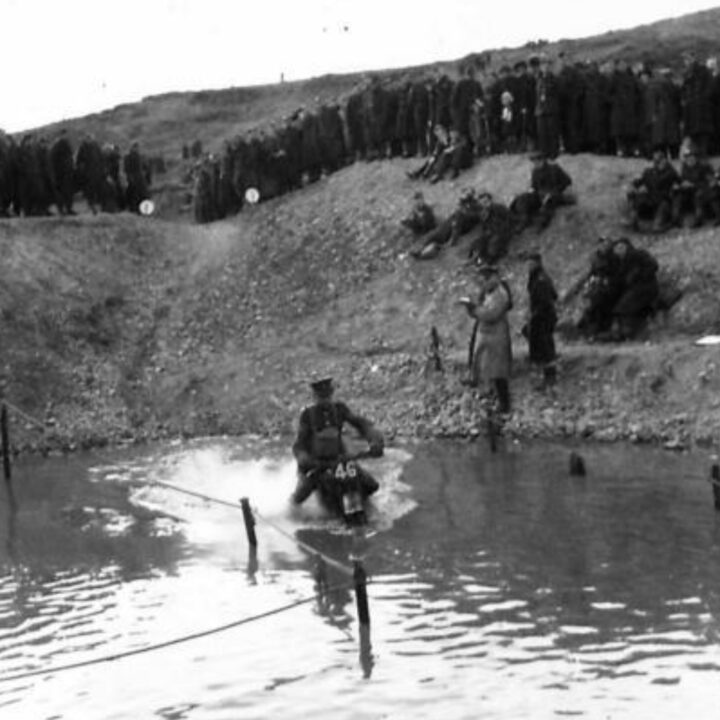 Military and civilian spectators watch the action at the water splash. British Army motorcycle trials held at the old lead mines at Whitespots near Conlig, Co. Down.