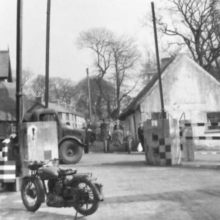 A traffic control policeman of 2/3 Traffic Control Company, Corps of Military Police using a new type of signal to help direct traffic flow in Ballynure, Co. Antrim.