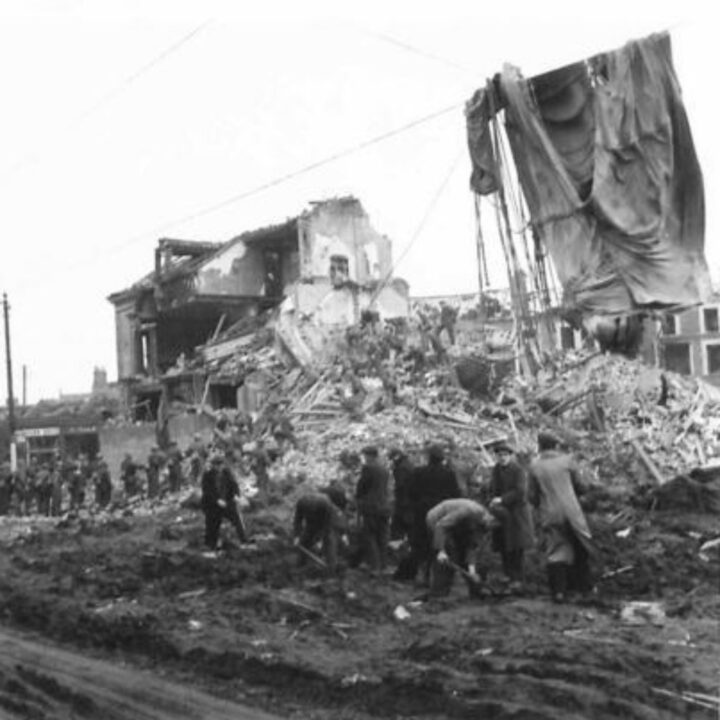 Soldiers at work clearing up rubble and debris in the aftermath of the Easter Raid of the Belfast Blitz. Material from a parachute mine hangs from overhead cables on Antrim Road, Belfast.