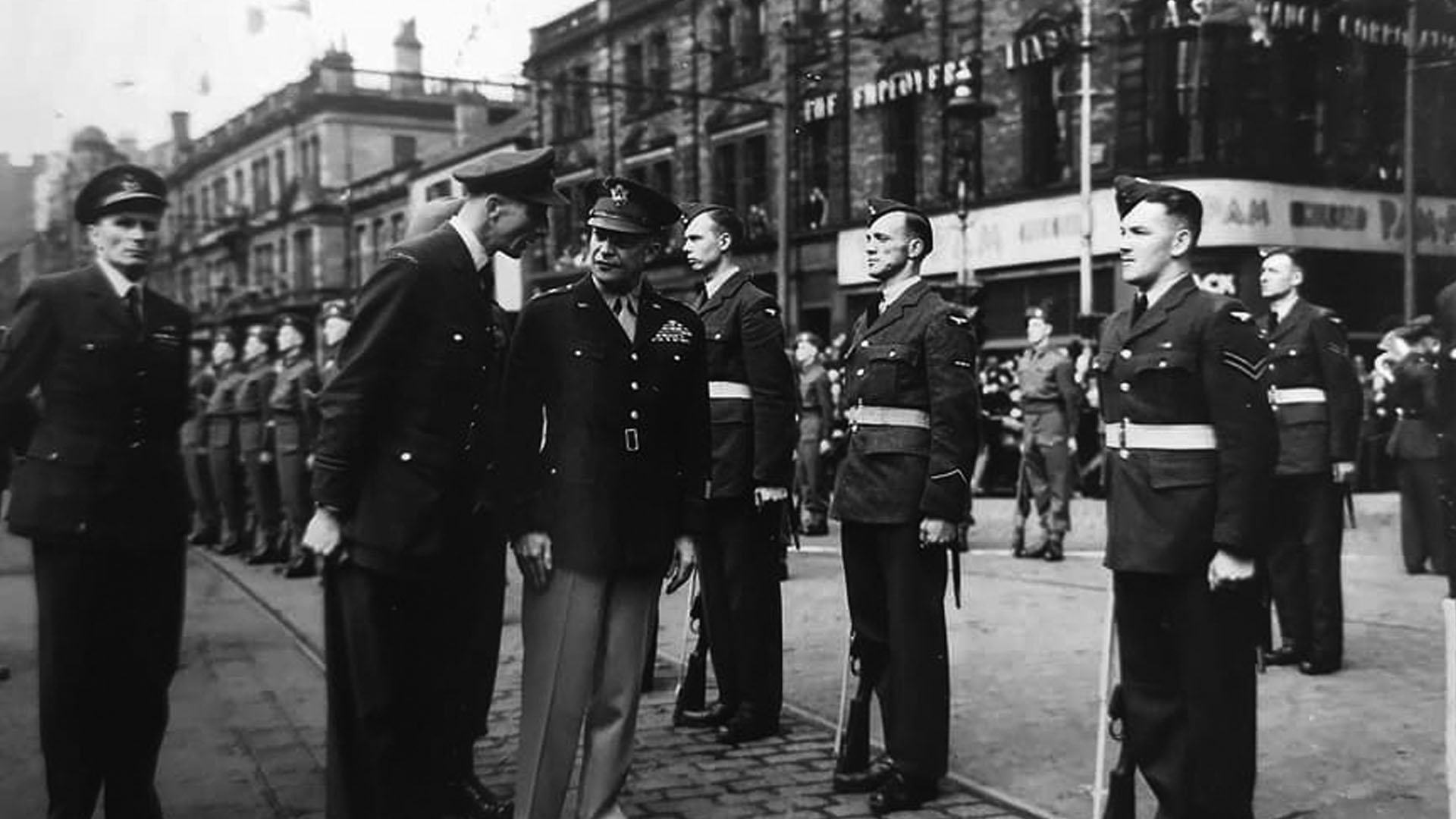 General Dwight D. Eisenhower along with Air Commodore A.R. Churchman, and Flight Lieutenant A. Potts inspect military personnel on Donegall Square North near Belfast City Hall.