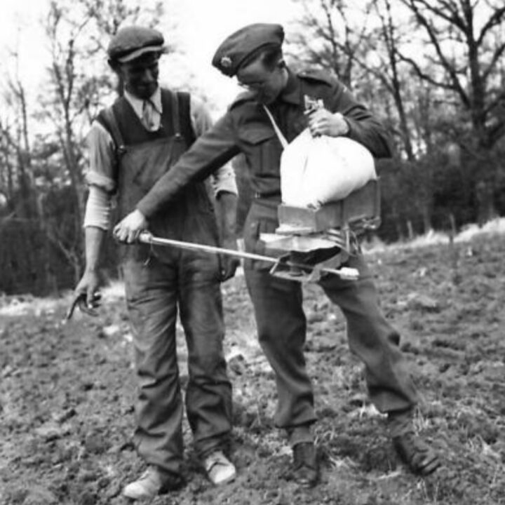 Soldiers sowing corn using a fiddle on farmland near Shane's Castle, Randalstown, Co. Antrim. During the Second World War, soldiers based in Northern Ireland received tuition in agricultural techniques to help with the war effort.