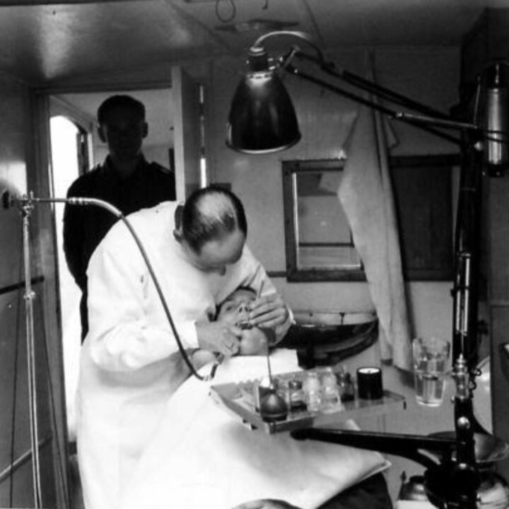 Dentistry work underway in a mobile dental van in a converted trailer caravan used by the Army Dental Corps at No. 21 Mobile Dental Unit at Warrenpoint, Co. Down.