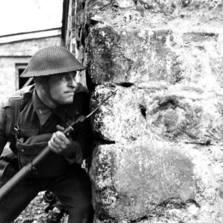 A British Army soldier with a rifle and fixed bayonet awaits a potential attack during training in street fighting in Northern Ireland.