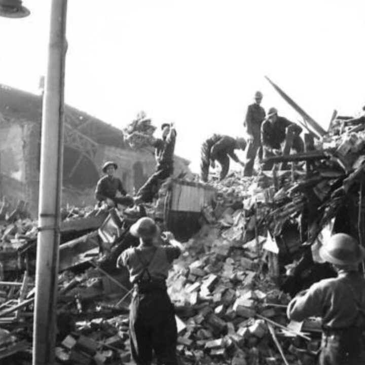 Soldiers of Royal Inniskilling Fusiliers assist with clearing up bomb damage at Newtownards Road, Belfast in the aftermath of the Fire Raid of the Belfast Blitz.