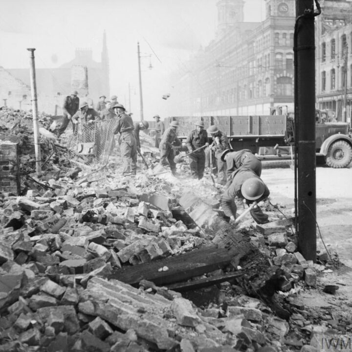 Soldiers of the Royal Welch Fusiliers assist with clearing up bomb damage on York Street, Belfast in the aftermath of the Fire Raid of the Belfast Blitz.