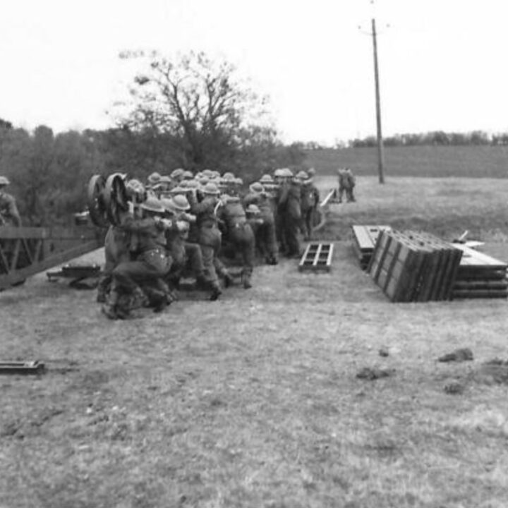 Sappers using their body weight to balance girders pushed across the river during a demonstration by 61st Divisional Engineers at Agivey, Co. Londonderry.
