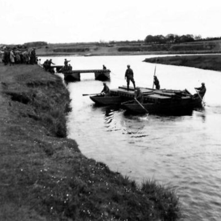 Moving rafts down the river to the site chosen for bridging during a demonstration by 61st Divisional Engineers at Agivey, Co. Londonderry.
