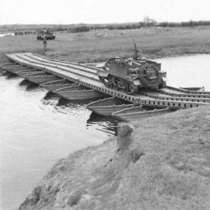 A Universal Carrier crosses a river constructed of boats during a demonstration by 61st Divisional Engineers at Agivey, Co. Londonderry.