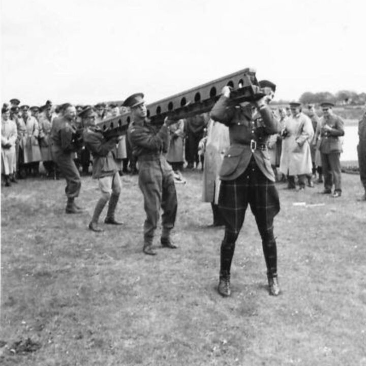 Brigadier C.D. Drew, Brigadier R.H. Farren C.R.A., Major General A. St. Q. Fullbrook-Leggatt D.S.O., M.C., and Brigadier F.A. Hawkins M.C., take part in some friendly girder lifting competition during a demonstration by 61st Divisional Engineers at Agivey, Co. Londonderry.