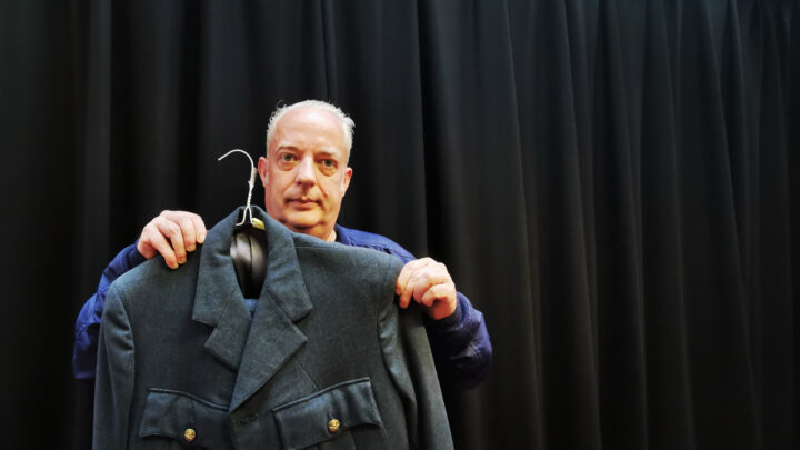 Adrian Aiken of Belfast displays his grandfather's A.R.P. Warden uniform at The Linen Hall, Belfast during the Their Finest Hour digital collection day - the first of its kind in Northern Ireland.