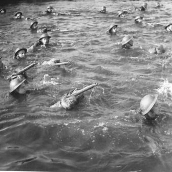 Soldiers of 8th (Nottinghamshire) Battalion, The Sherwood Foresters, 148th Independent Infantry Brigade with full kit including rifles and bayonets swimming across the Six Mile Water near Muckamore, Co. Antrim.