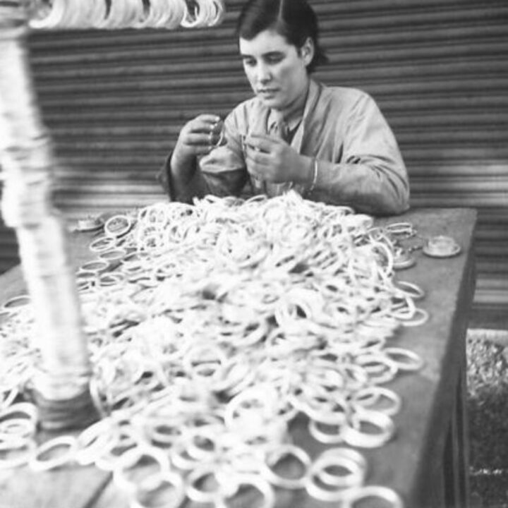 A member of the Auxiliary Territorial Service working with thousands of washers for the screw plugs of petrol cans at a petrol distributing centre in Northern Ireland.