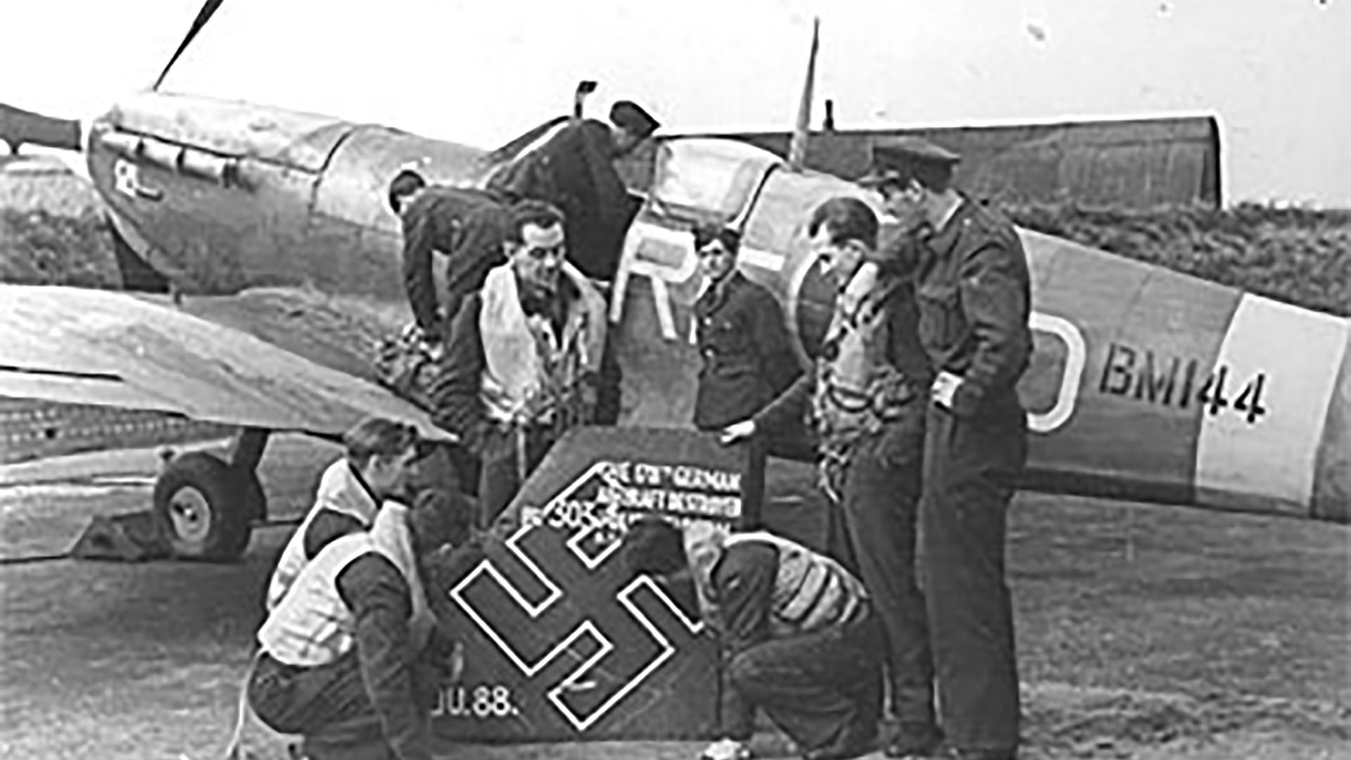 Air crew of R.A.F. 303 (Kościuszko) Squadron, one of several Polish squadrons, chalk up their 178th battle victory over the Luftwaffe next to Supermarine Spitfire V BM144.