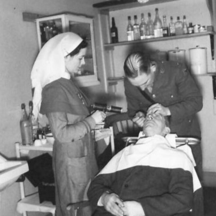 Ophthalmological and Optical Specialists examine a soldier in the minor operating theatre of a Military Ophthalmic Centre at No. 31 (London) General Hospital, Musgrave Park, Belfast.