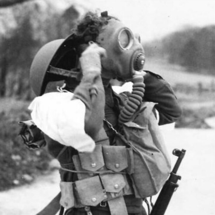 A soldier putting on a respirator demonstrates the wrong thing to do during a spray gas attack. These illustrative photographs are from a demonstration held in Northern Ireland.