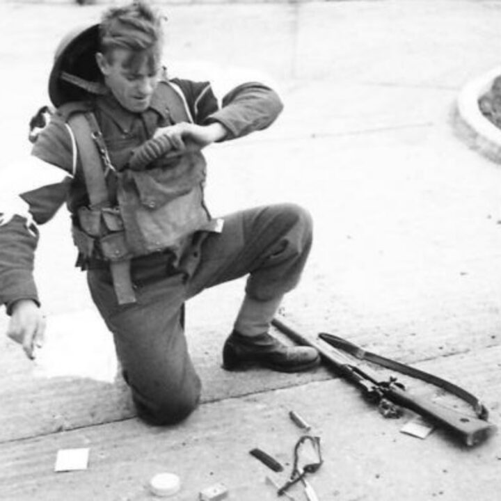 A soldier demonstrates the wrong things to carry in a gas mask container. These illustrative photographs are from a demonstration held in Northern Ireland.