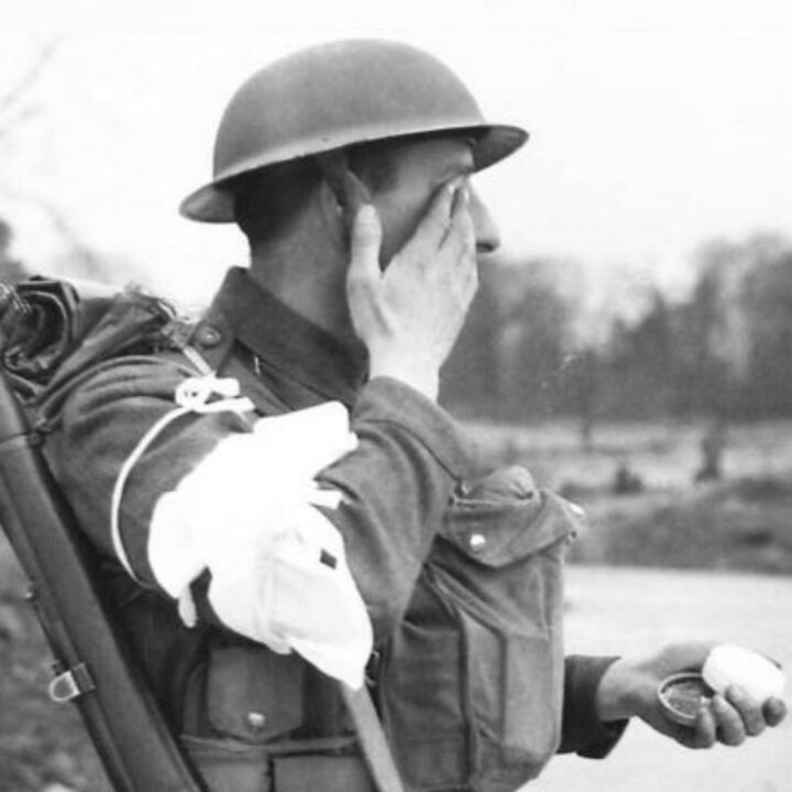 A soldier rubbing ointment on his eyes demonstrates the wrong thing to do during a spray gas attack. These illustrative photographs are from a demonstration held in Northern Ireland.