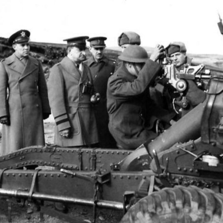 Major General Russell P. Hartle, commanding officer 34th (Red Bull) Infantry Division, United States Army, watches American gunners take their first shots with British 25-pounder guns accompanied by American and British artillery officers in Northern Ireland.