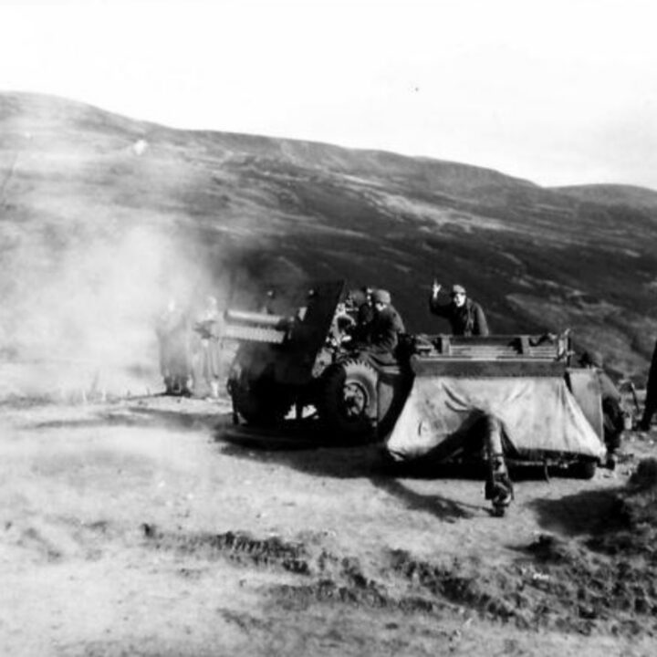 Major General Russell P. Hartle, commanding officer 34th (Red Bull) Infantry Division, United States Army, watches American gunners take their first shots with British 25-pounder guns accompanied by American and British artillery officers in Northern Ireland.