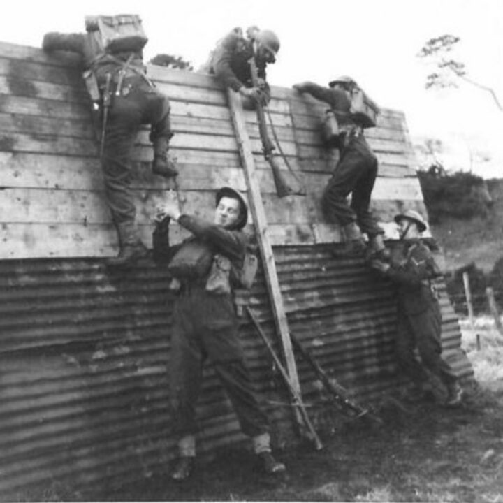 Soldiers of 2/5th Battalion, Lancashire Fusiliers scale a wall while training near Keady, Co. Armagh.